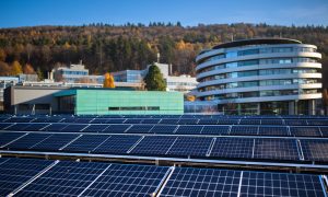 The newly installed solar array at EMBL's site in Heidelberg. In the foreground are rows of solar panels, with the ATC building shown behind.