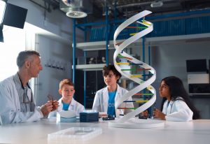 Scientist and three children with large DNA helix model